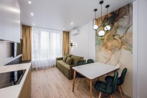 a living room with a table and a couch at Petrovdom Apartments 18-100 in RC Poetika, 25E Degtyarivska Street, Building 3, First Collection in Kyiv