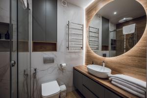 a bathroom with a sink and a mirror at Petrovdom Apartments 18-100 in RC Poetika, 25E Degtyarivska Street, Building 3, First Collection in Kyiv +23 photos