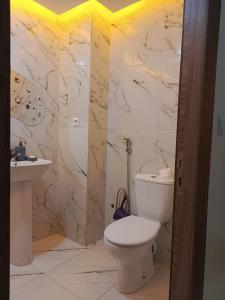 a bathroom with a toilet and a sink at El jadida in El Jadida
