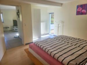 a bedroom with a large bed and a large window at Gemütliche FeWo im Grünen in Birstein