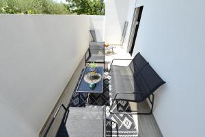 a patio with a table and chairs on a balcony at Amantis in Zadar