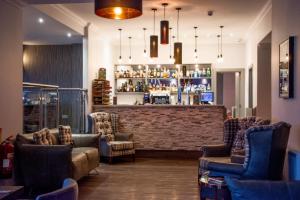 a bar with couches and chairs in a room at The Knowes Hotel & Restaurant in Macduff