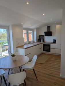 a kitchen with a table and a table and chairs at Emden - Ferienwohnung mit Kanal-Blick in Emden