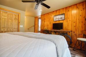 a bedroom with a bed and a flat screen tv at Ponderosa Cabin at Highland Meadows in Hot Springs +13 photos