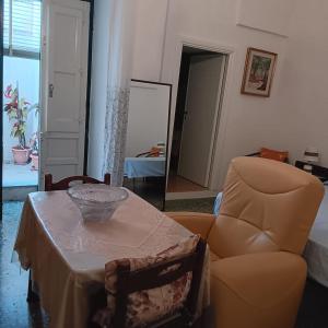 a living room with a table and a chair at Casa Nashi in Ugento