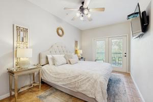 a bedroom with a bed and a ceiling fan at The Village at Gruene in New Braunfels