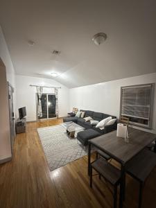 a living room with a couch and a table at Cozy City Nest in Jersey City