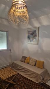 a room with a bed and a chandelier at In The Heart Of Medina Bizerte and 5 min from the beach in Bizerte
