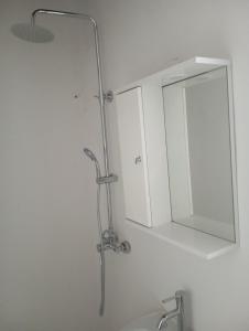 a bathroom with a mirror and a sink at Ateni Beachfront in Aténi