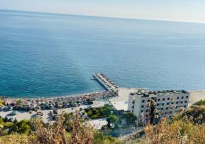 a view of a beach with a building and the ocean at Beus home in Durrës