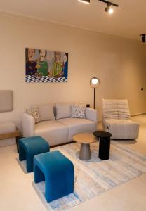a living room with a couch and a table at Luxury Modern Studio Ensuite By Beithady BH-26-004 in New cairo