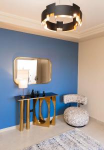 a room with a table and a mirror and a chair at Luxury Modern Studio Ensuite By Beithady BH-26-004 in New cairo +50 photos