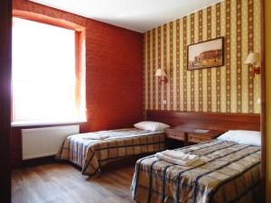a hotel room with two beds and a window at RA na Rybinskoy 7 in Saint Petersburg