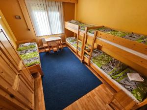 an overhead view of a room with three bunk beds at Turistická ubytovňa Forgáč in Oravský Podzámok