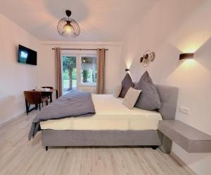 a bedroom with a king sized bed and a table at Ferienwohnung DanVie in Varel