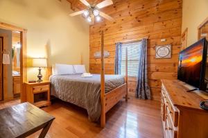 a bedroom with a bed and a flat screen tv at Anglers Bend By Avada Properties in Pigeon Forge