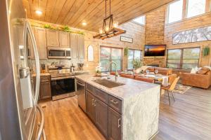 a kitchen with a sink and a refrigerator in a room at Amazing Grace By Avada Properties in Sevierville