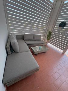 a living room with a couch and a table at Villa acqua e sale in Santa Maria Del Focallo