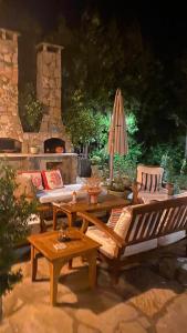 a patio with couches and a table and an umbrella at Kamarca House Hotel in Ortaca +44 photos