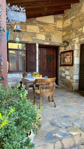 a patio with a wooden table and a bench at Kamarca House Hotel in Ortaca
