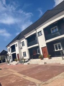 a large white building with large windows on it at Richj luxury apartment in Benin City
