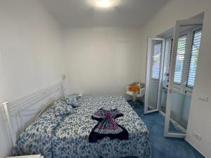 a bedroom with a bed with a dress on it at Bellessere in vacanza Forio d’ Ischia in Forio d'Ischia