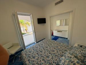 a bedroom with a bed and a sliding glass door at Bellessere in vacanza Forio d’ Ischia in Forio d'Ischia