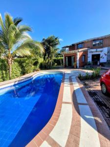 a swimming pool in front of a house at Alojamiento campestre Juanita Bonita in Ibagué