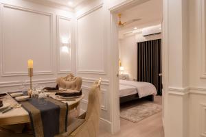 a hotel room with a table and a bed at The Versailles Suite A Designer Home in Dhaka in Dhaka