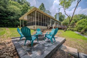 a group of chairs sitting in front of a house at Riverfront Home w Gameroom & Screened Porch in Ellijay