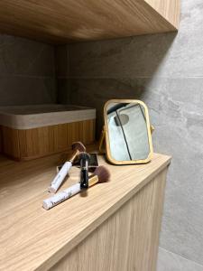 a mirror and a brush sitting on a counter at Augustów apartament nad jeziorem in Augustów +23 photos