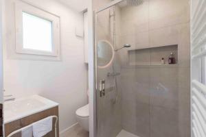 a bathroom with a shower with a toilet and a sink at Cabana & Studio Alpin Annecy - Terrasse Parking in Argonay