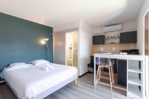 a bedroom with a bed and a desk in it at Cabana & Studio Alpin Annecy - Terrasse Parking in Argonay