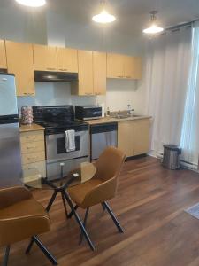 a kitchen with a table and chairs and a stove at downtown vancouver independent affordable suit 1 in Vancouver