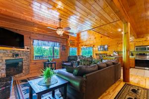 a living room with a couch and a fireplace at Bear Essentials Lodge By Avada Properties in Sevierville