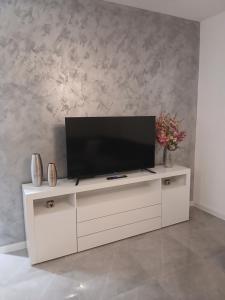 a white entertainment center with a flat screen tv on it at Apartman Jurišić in Posušje
