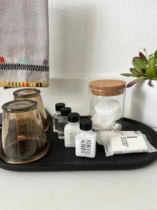 a black tray with cosmetics on a table at Wanderers Retreat House in Comfort