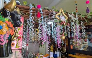 a bunch of flowers hanging from a wall at Sumaq Wari Hotel in Ayacucho