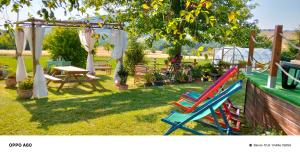 a group of colorful chairs sitting in a yard at MANSARDA VITI - Sguardo su Frontone - in Frontone