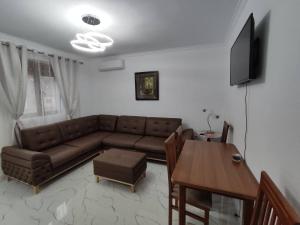 a living room with a couch and a table at Korca Apartament Koci in Korçë