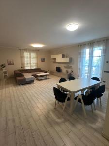 a living room with a table and chairs and a couch at Luxury Villa Cenaia in Cenaia Vecchia