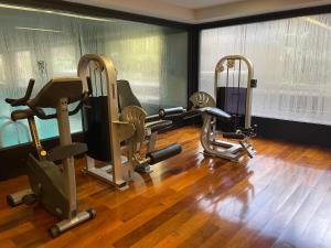 a gym with three treadmills and elliptical machines at Loft Full Amenities en Retiro in Buenos Aires