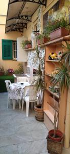a patio with a table and chairs and plants at Ribero's Home - Center - Quite Zone in Sanremo