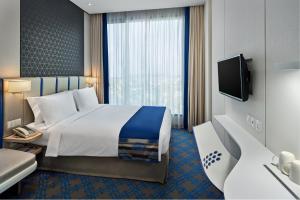 Holiday Inn Express Singapore Katong by IHG客房内的一张或多张床位
