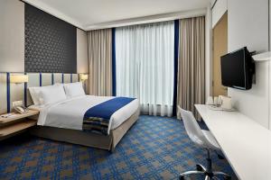 Holiday Inn Express Singapore Katong by IHG客房内的一张或多张床位