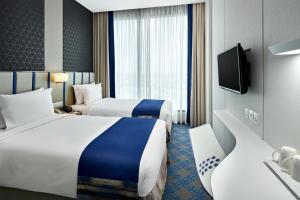 Holiday Inn Express Singapore Katong by IHG客房内的一张或多张床位