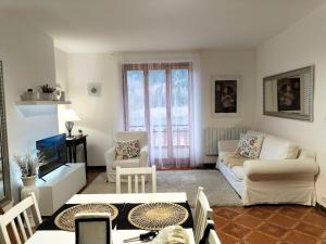 a living room with a couch and a table at Castori 1 in Prazzo