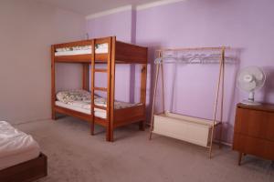 a bedroom with two bunk beds and a fan at Guest House Relax in Březí