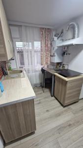 a kitchen with a sink and a counter top at Casa AVA 2 Mai in 2 Mai