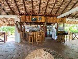 a bar in a resort with a counter and stools at Casa Paraiso Hotel Boutique in Puerto Escondido
